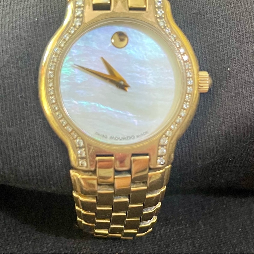 MOVADO gold plated. Mother of pearl and diamonds on each side. Sapphire crystal.
